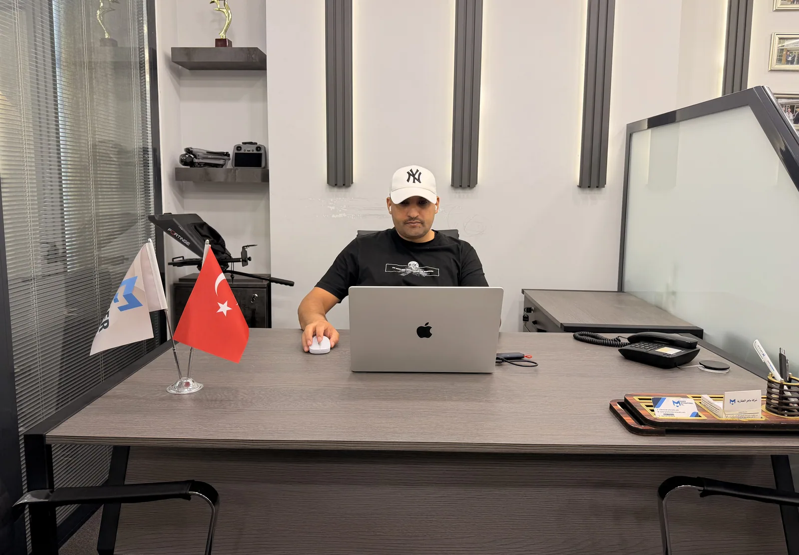 A team member at his desk in the media room